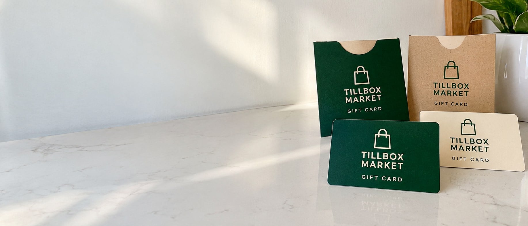 Custom printed plastic gift cards and card holders on a counter